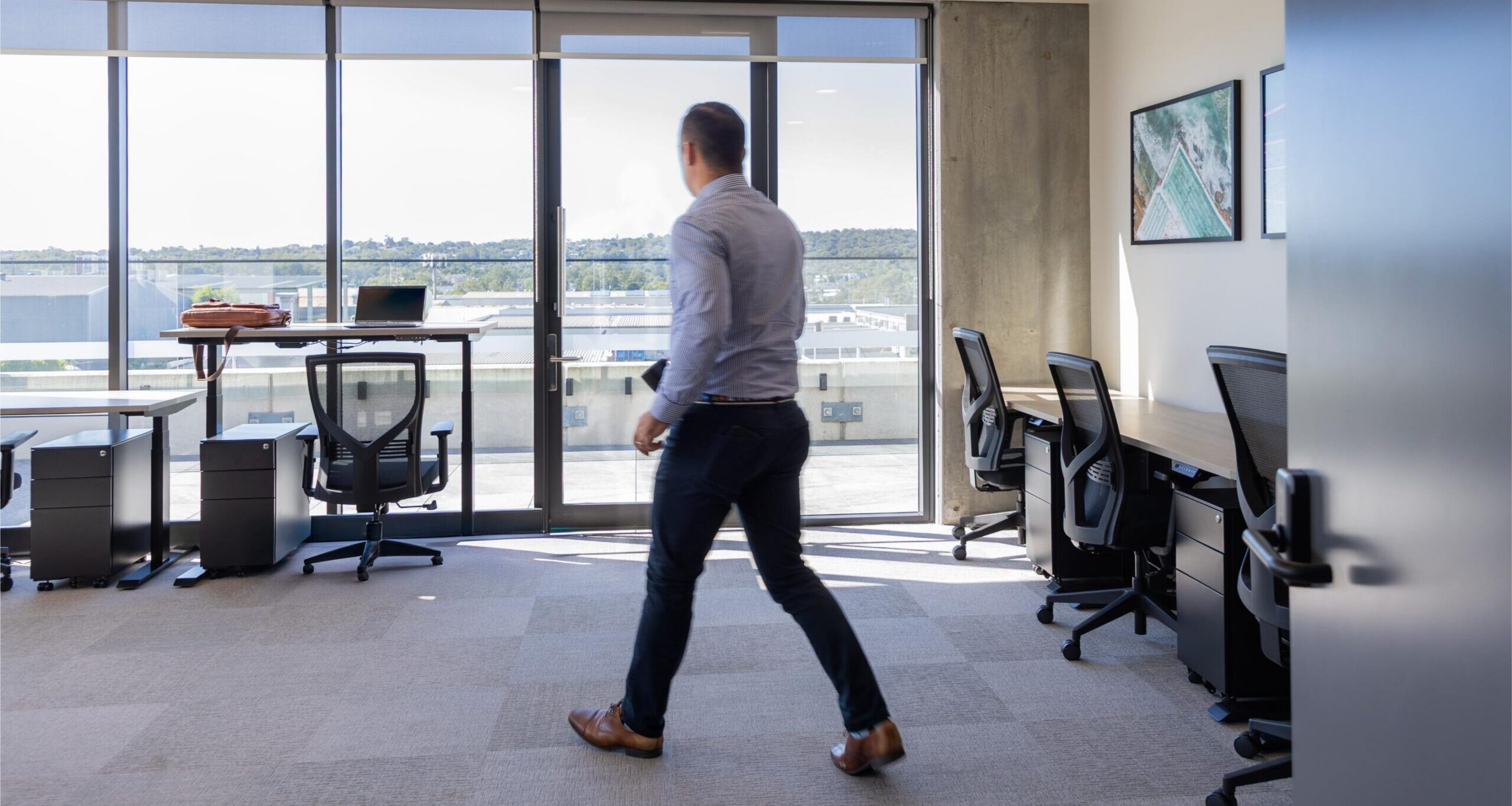 Man walking through private office which is part of coworking space in Brisbane